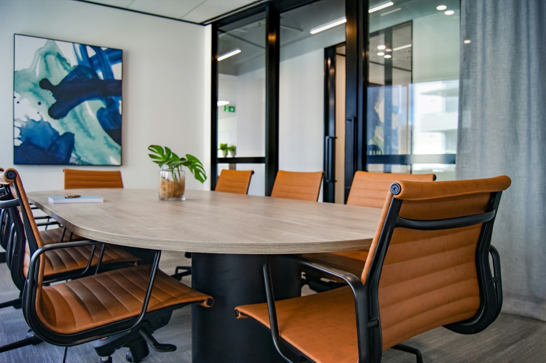 Meeting room with a round table and leather chairs